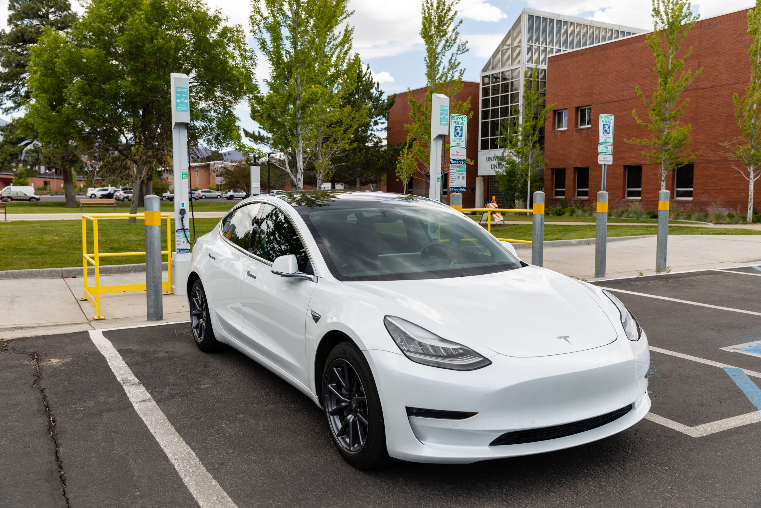 An electric vehicle charges at a charging station.