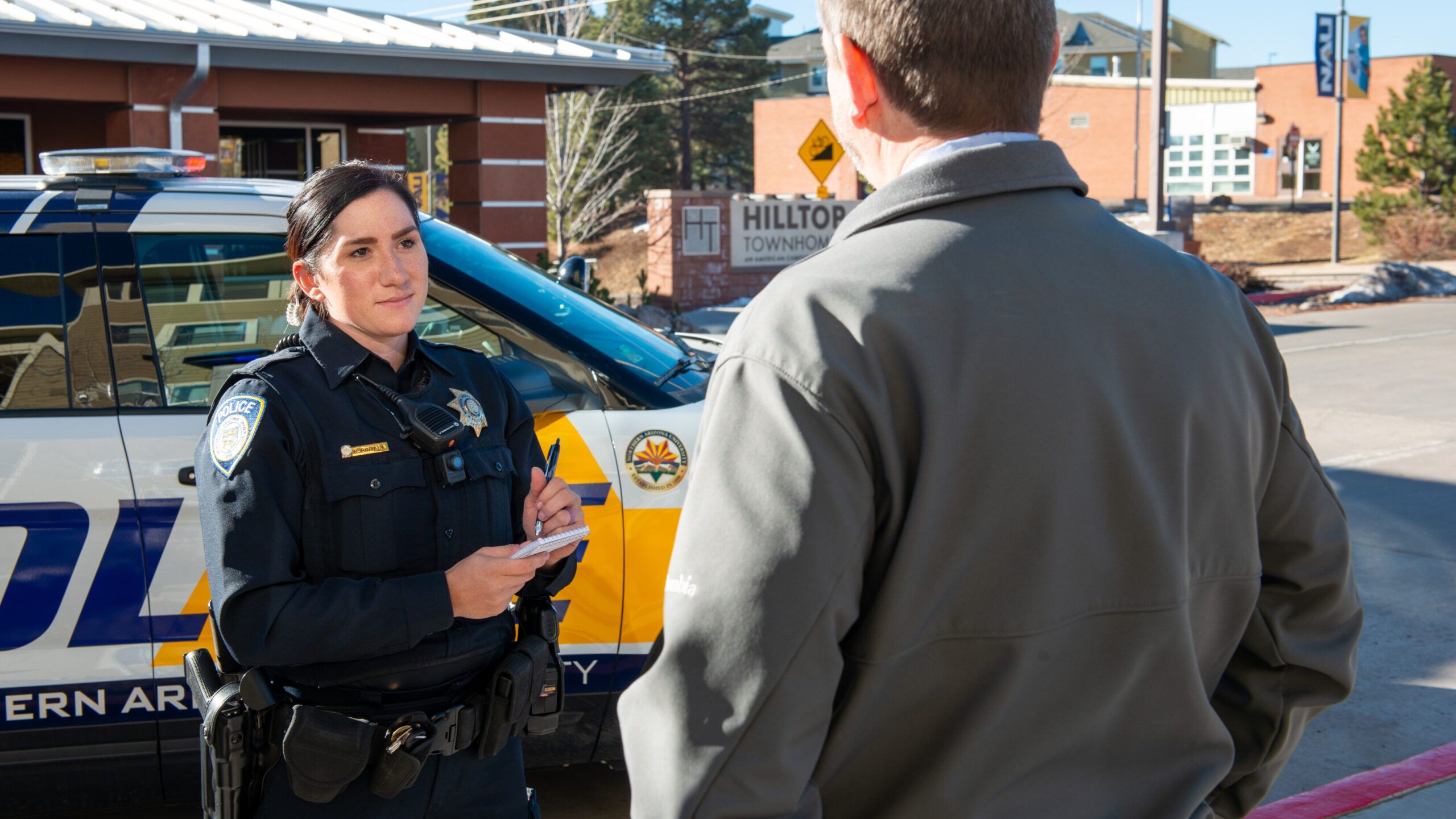 An N A U P D talks to a pedestrian on the Flagstaff Campus.