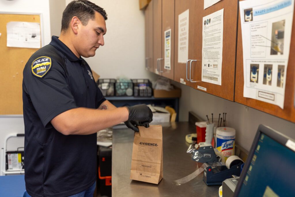 An NAU Police officer bags evidence. 