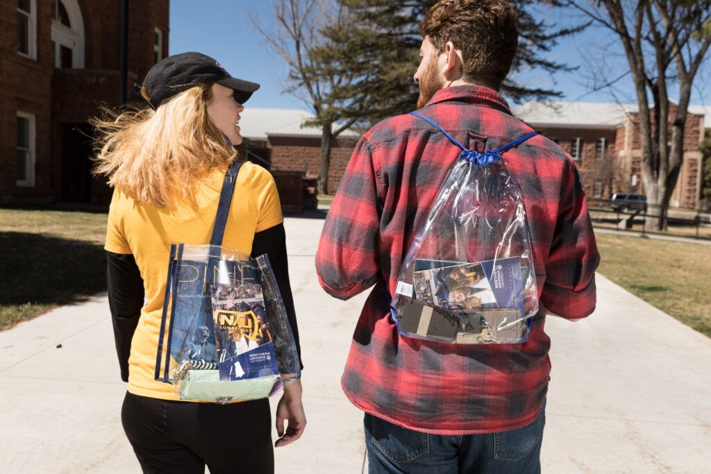 Students prepare for N A U Commencement by getting clear bags at the bookstore.