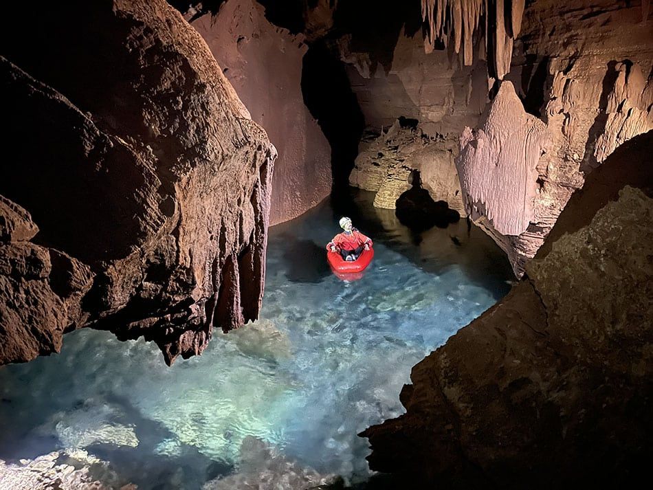 A researcher on a raft in a flooded cave in the Grand Canyon.