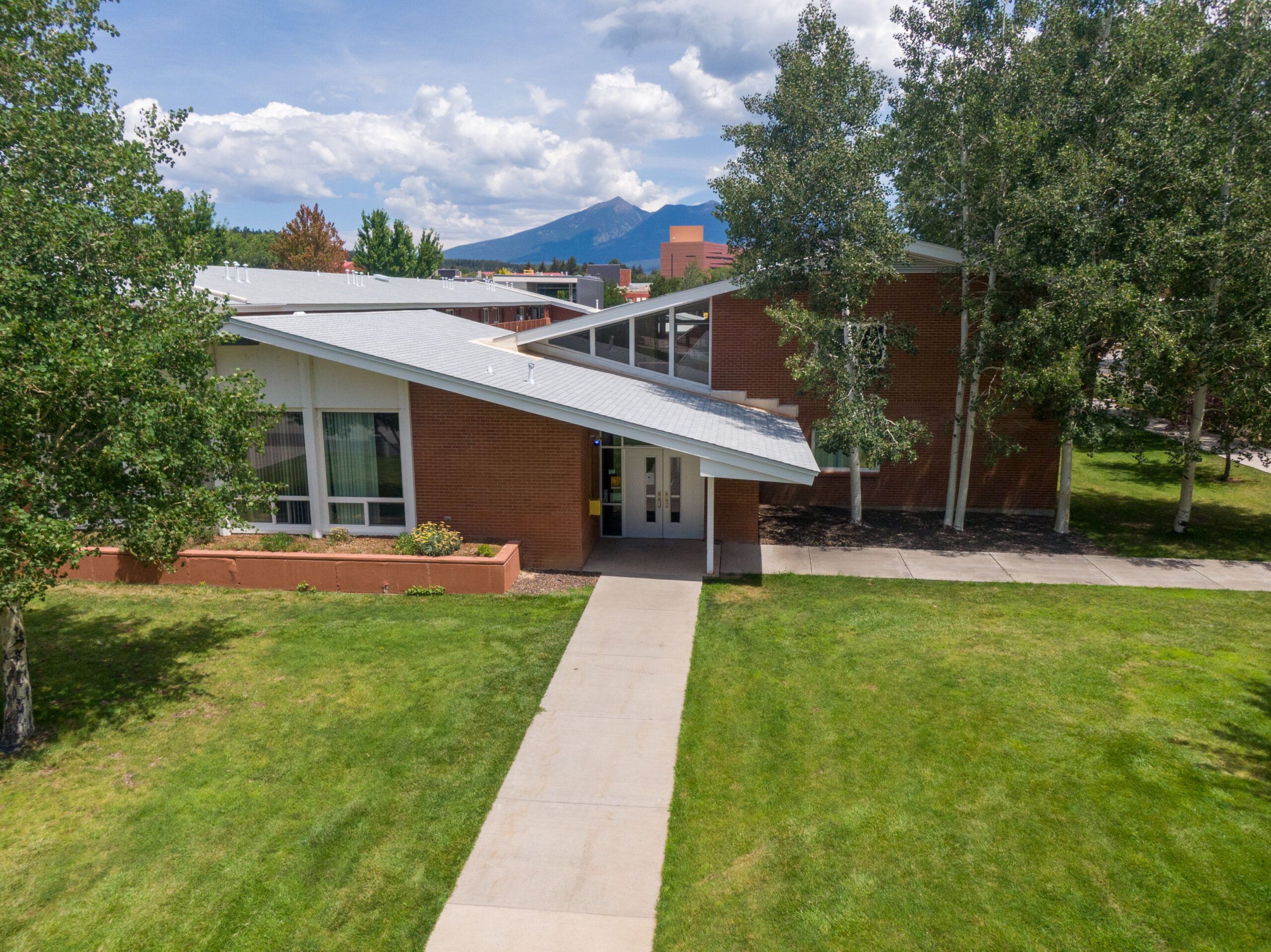 The outside of McDonald Hall, a residential hall, on a summer day at NAU campus.