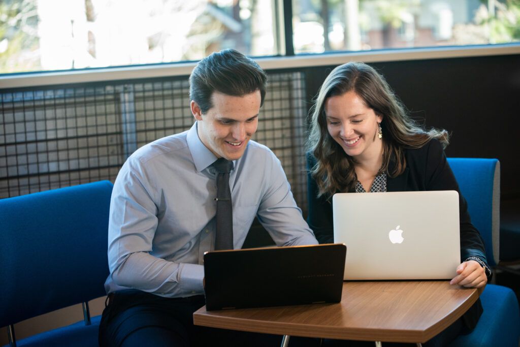 Two N A U students working together on their laptops.