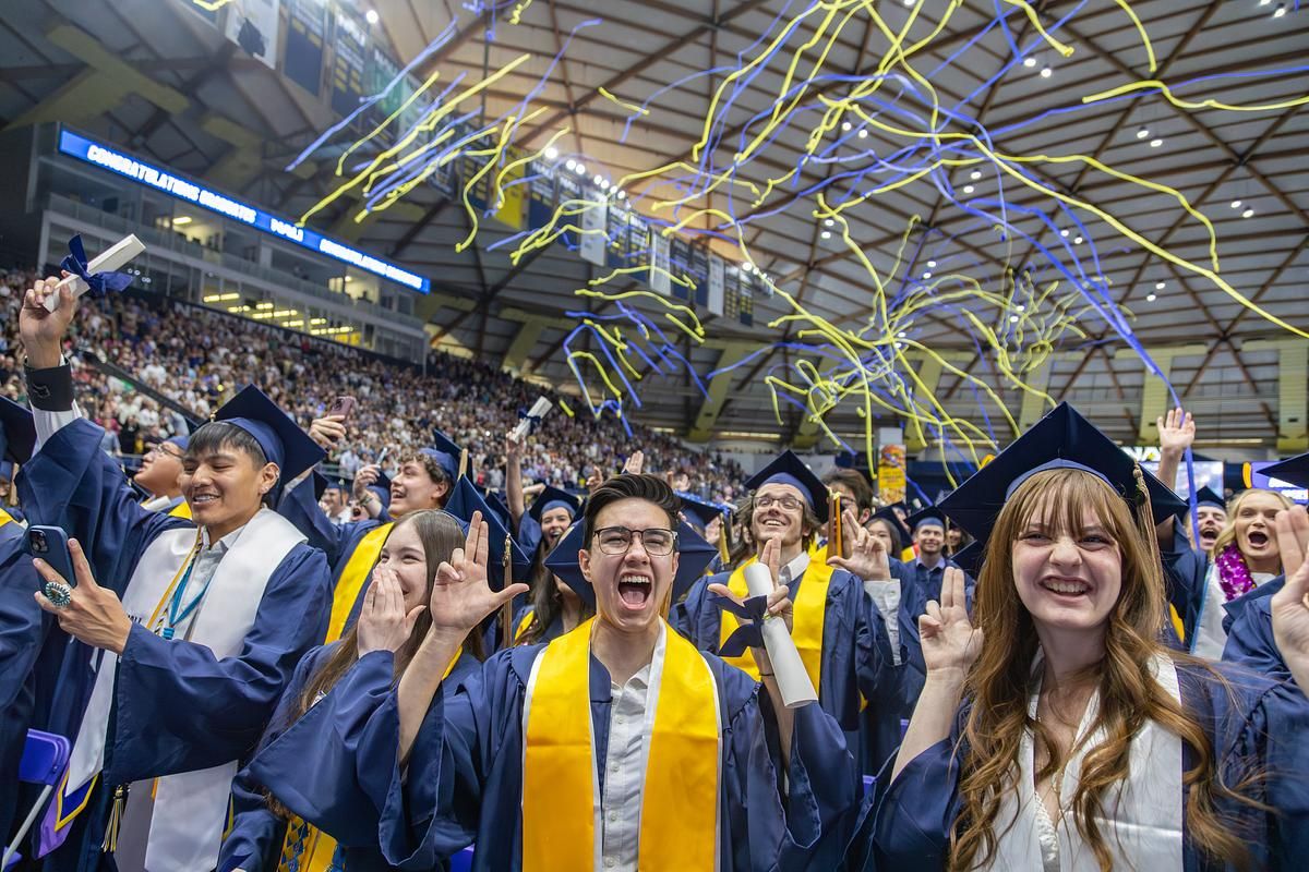 N A U grads cheer and hold up L J's at commencement.