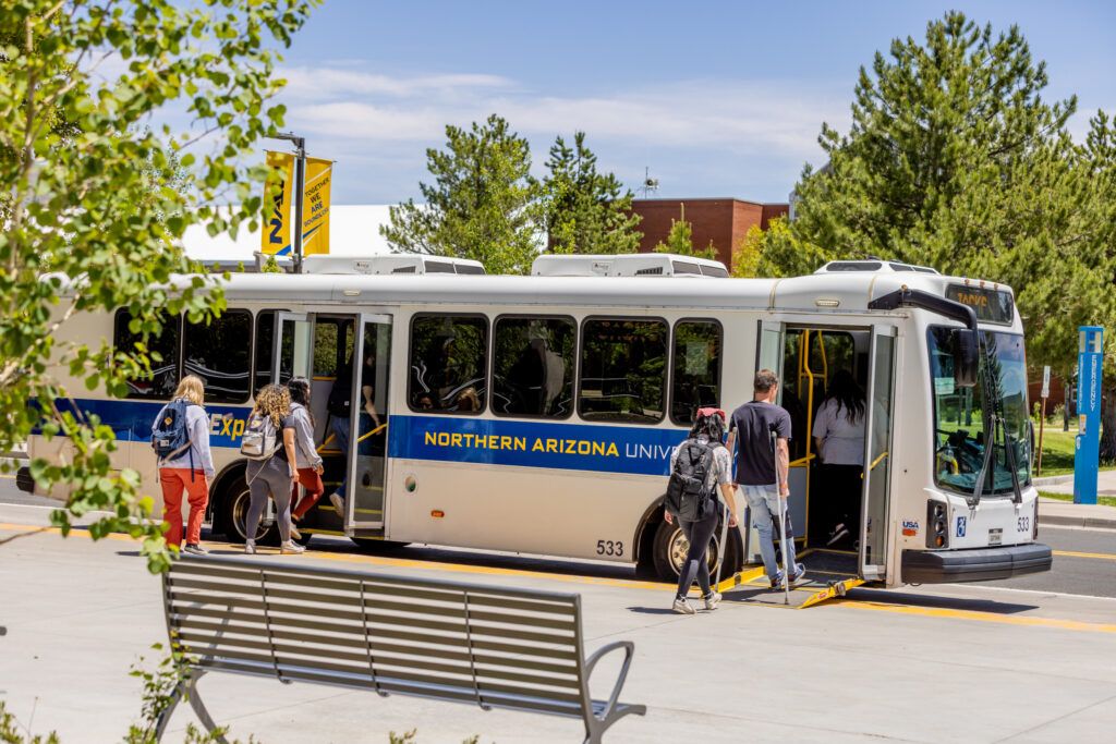 Students getting on the campus shuttle by the University Union at N A U. 